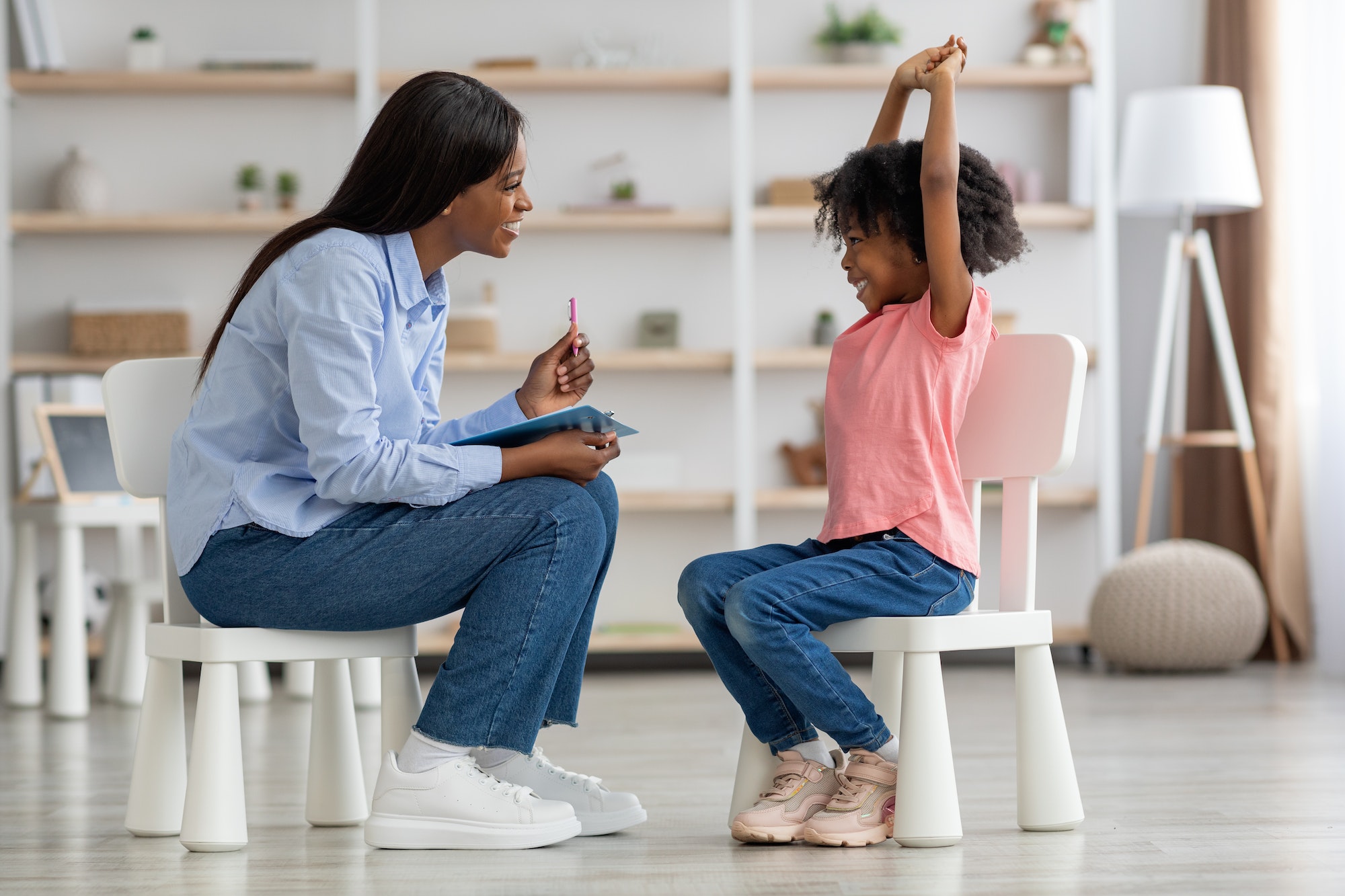 Excited cute little black girl at child psychologists office
